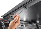 Hand adjusting the latch on BAK 05-15 Toyota Tacoma 5ft Bed BAKFlip G2 truck bed cover.