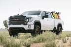 Cognito 20-24 Chevy/GMC Silverado/Sierra 2500/3500 HD 2WD/4WD 3in Standard Leveling Lift Kit on GMC truck in off-road setting.