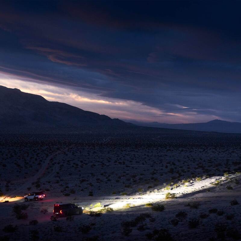 KC HiLiTES Gravity Titan LED Light Bar - 50in. (8-Light) illuminating off-road vehicles at night