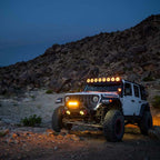 KC HiLiTES Gravity Titan LED Light Bar - 50in. (8-Light) on Jeep Wrangler in off-road setting at night.