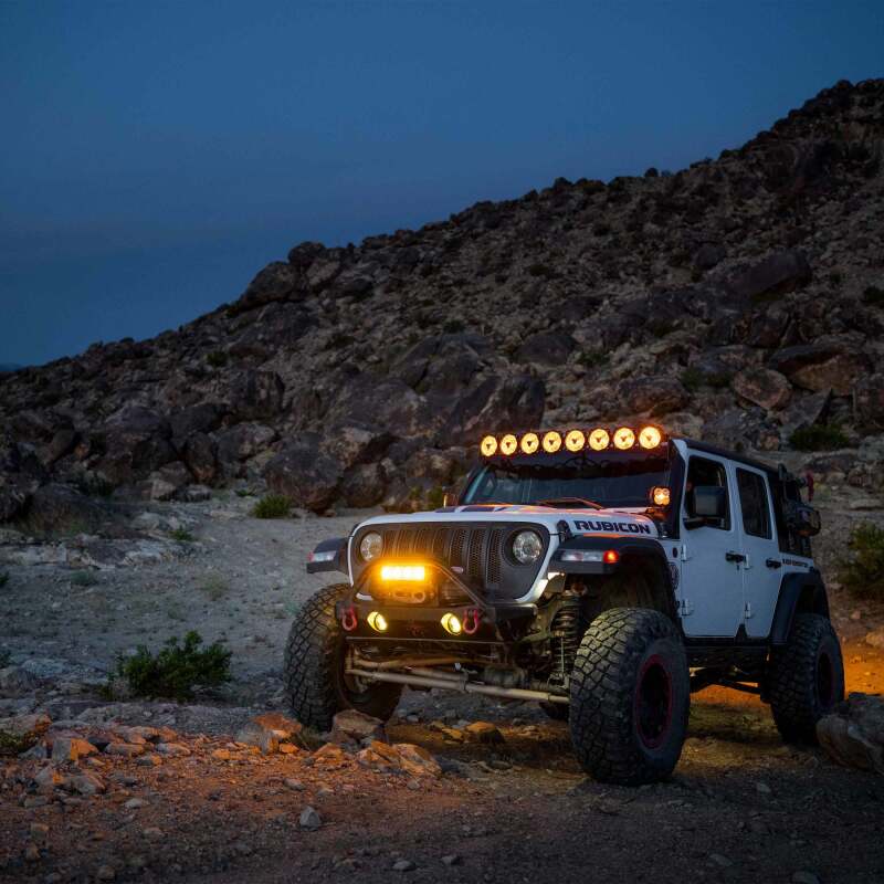 KC HiLiTES Gravity Titan LED Light Bar - 50in. (8-Light) on Jeep Wrangler in off-road setting at night.