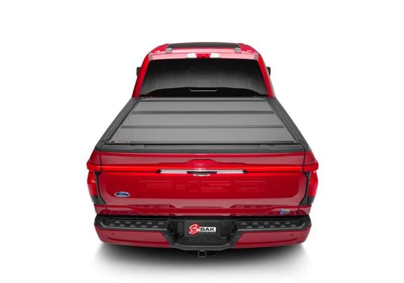 BAK 21-22 Ford F-150 (Incl. 2022 Lightning) BAKFlip MX4 5.7ft Bed Cover - Matte Finish on red truck