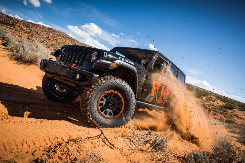 Fox 2018+ Jeep Wrangler JL 2.0 Performance Series 11.6in Smooth Body IFP Rear Shock 3.5-4in. Lift in action on off-road terrain.
