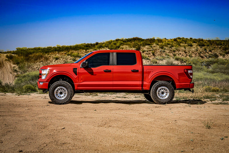 ICON 21-23 Ford F150 Tremor 2.5-3in 2.5 Series VS RR CDCV Coilover Kit on red F150 truck in desert landscape.