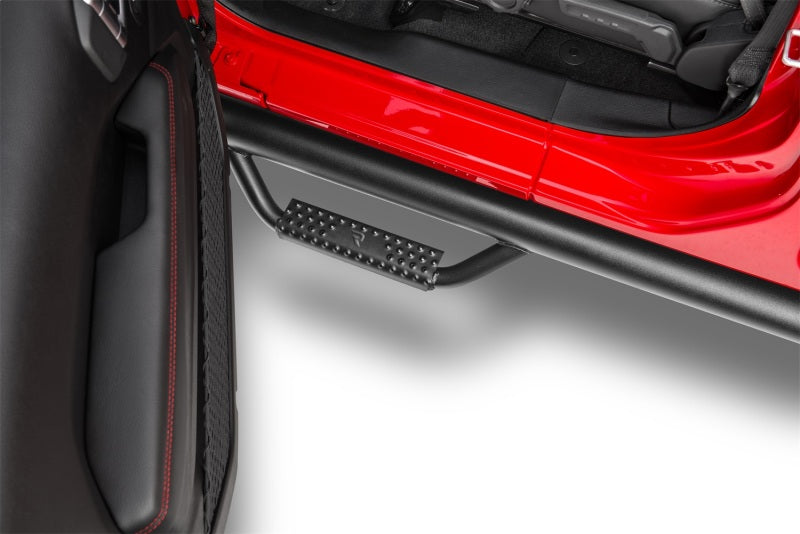 N-Fab Nerf Step 2018 Jeep Wrangler JL SUV 4 Door- Tex. Black - W2W - 3in. installed on red Jeep, showcasing durable design.