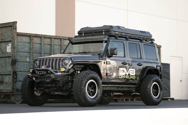 DV8 Offroad 18-23 Wrangler JL/Gladiator JT Spec Series Front Bumper on modified Jeep truck with offroad tires and accessories.