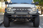 DV8 Offroad 21-22 Ford Bronco Factory Front Bumper Licence Relocation Bracket - Front on offroad truck with wheels