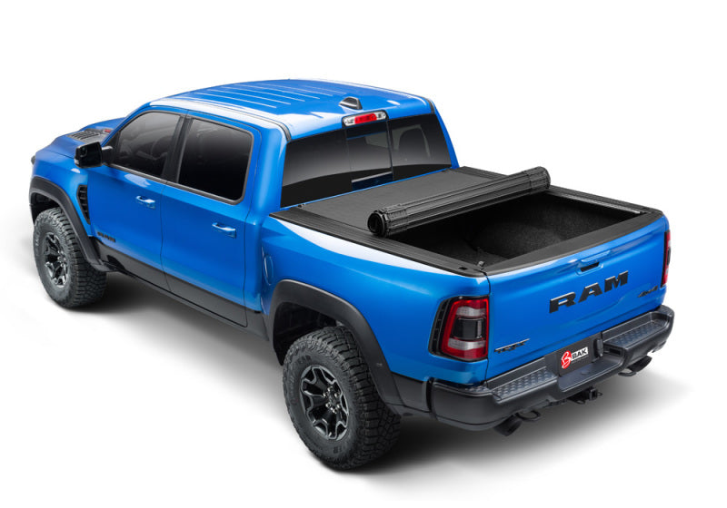 BAK 19-21 Dodge Ram w/ Ram Box Revolver X4s 5.7ft Bed Cover showing a blue truck with cover.