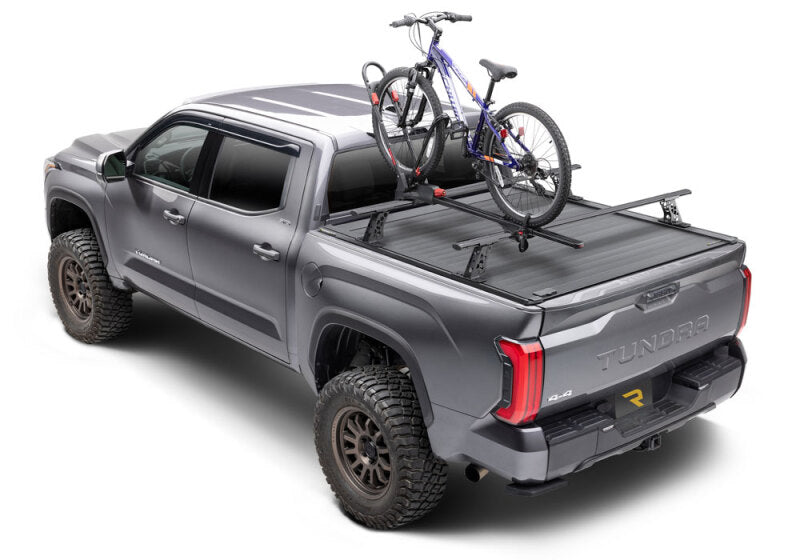 Retrax 2007-2020 Toyota Tundra CrewMax 5.5ft Bed RetraxPRO XR with Deck Rail System on offroad truck with bike