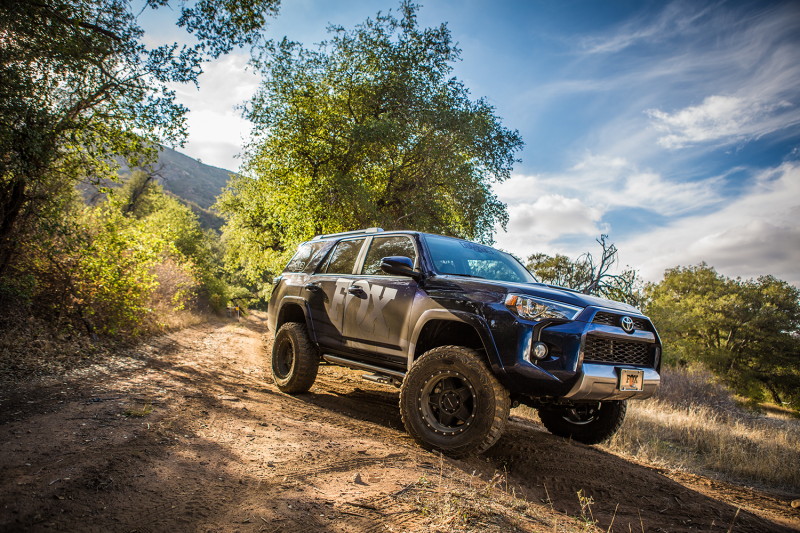 Fox 07+ Toyota Tundra 2.0 Performance Series 11.6 Smooth Body IFP. Rear Shock w/ 5-7in. Lift on an off-road trail.