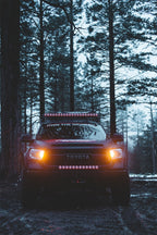 Toyota truck with Rigid Industries 20in Adapt Light Bar in forest