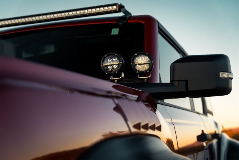 Rigid Industries 360-Series 4in LED Off-Road Spot Beam - RGBW (Pair) mounted on truck mirror for offroad performance upgrades.
