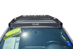 DV8 Offroad 2016+ Toyota Tacoma Aluminum Roof Rack (45in Light) on vehicle roof with manual sticker.