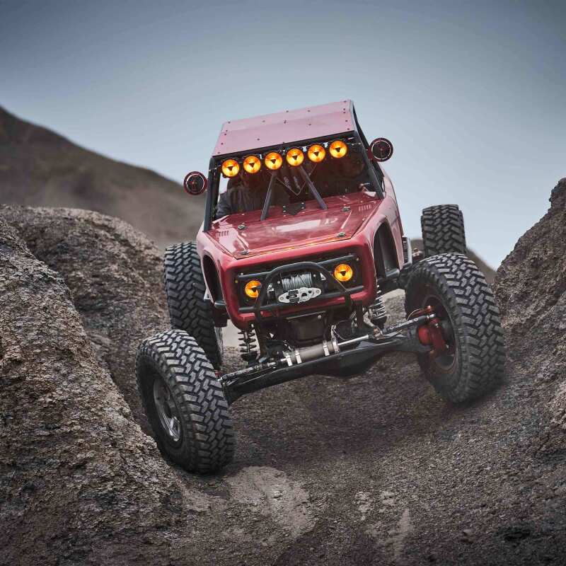 KC HiLiTES Gravity Titan LED Light Bar - 39in. (6-Light) on offroad truck climbing rocks.