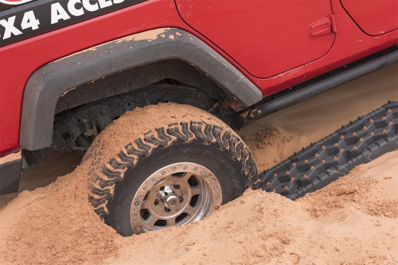 ARB Tred Pro Red recovery boards aiding off-road jeep tire in sand