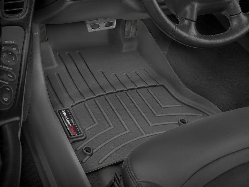 WeatherTech 97-2004 Chevy Corvette Front FloorLiner - Black installed in vehicle interior.