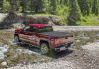 Retrax 14-up Chevy/GMC 6.5ft Bed / 15-up 2500/3500 RetraxPRO MX on offroad terrain with matte finish cover.