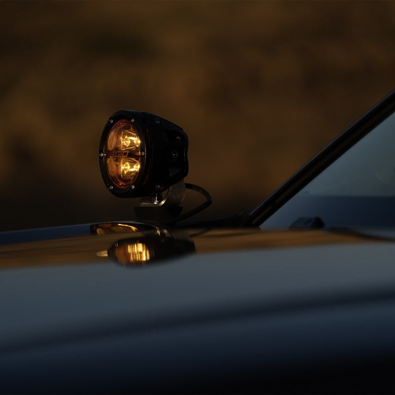 Rigid Industries 360-Series 4in Fog w/ Amber PRO Lens - White (Pair) on a vehicle roof for offroad lighting.