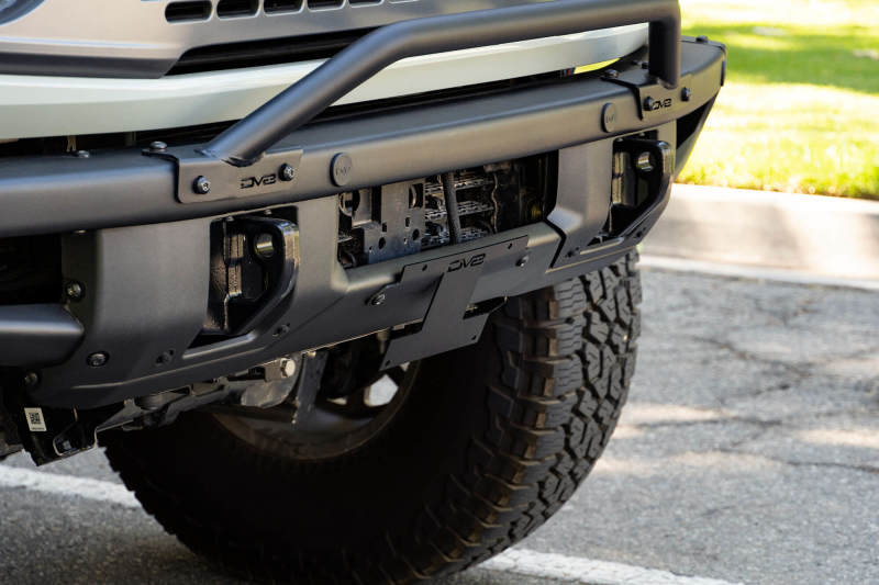 DV8 Offroad 21-22 Ford Bronco Factory Front Bumper Licence Relocation Bracket - Front on vehicle with offroad tires