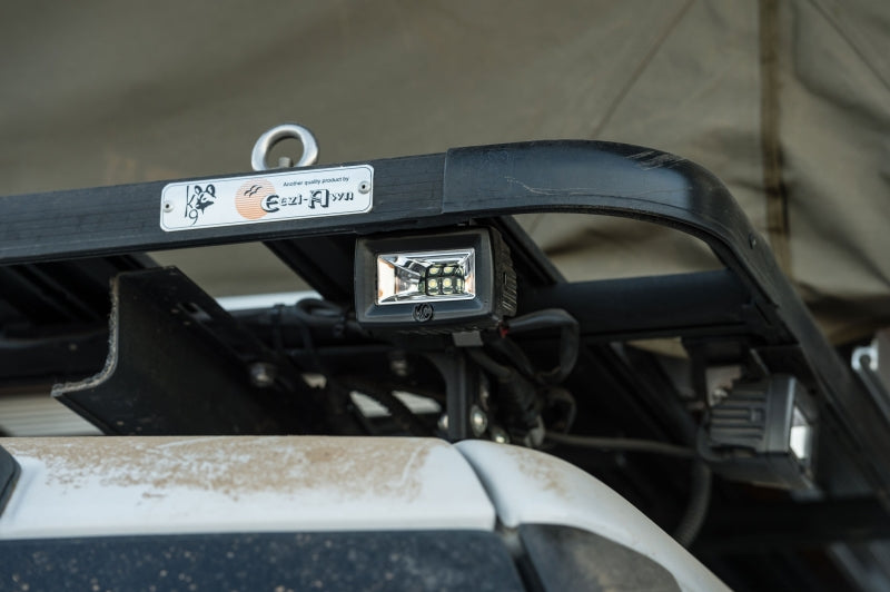 KC HiLiTES C-Series C2 LED 2in. Backup Area Flood Light 20w (Pair Pack System) - Black mounted on a vehicle roof rack