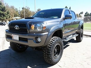 Toyota Tacoma with offroad wheels and suspension lift kits.